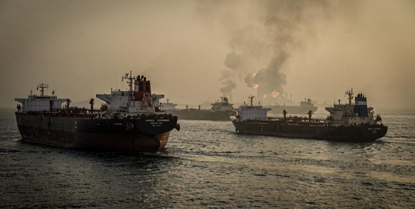 Strait of Hormuz crisis showing oil tankers anchored amid rising US Iran tensions